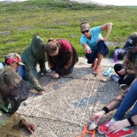 Roman Lamouelle (second from left) taking part in caribou photo survey exercise during Tundra Science and Culture Camp 